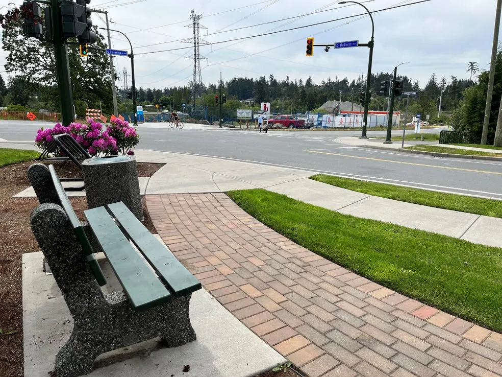 Photo of a road intersection with overhead traffic signals