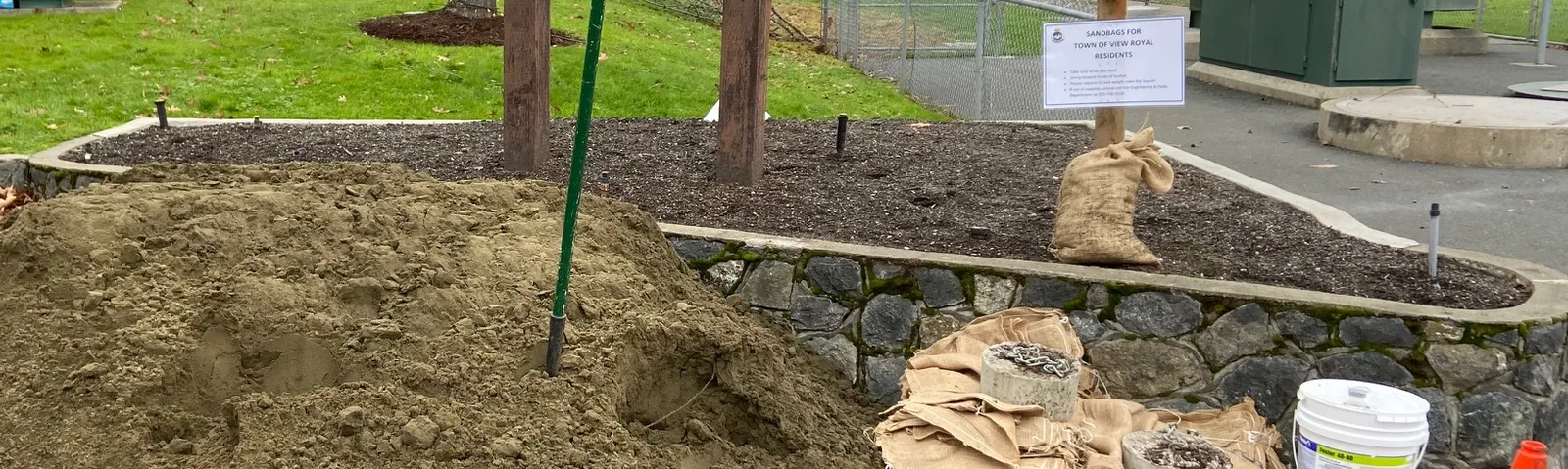 A large pile of sand and filled sandbags prepared for residents at Helmcken Centennial Park