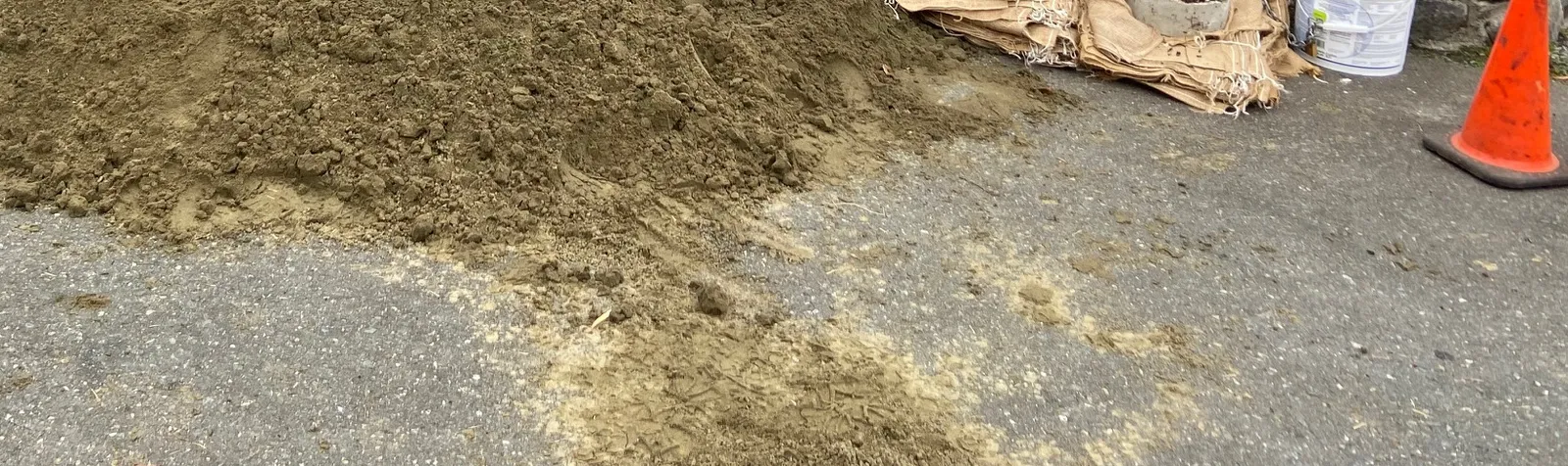 Close up of the sand bagging station on the pavement with a shovel and bucket
