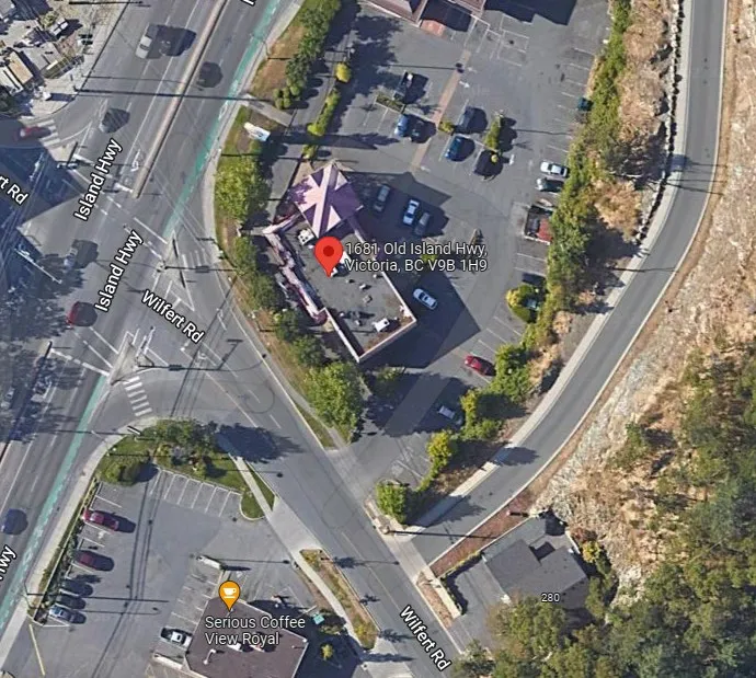 Aerial satellite map of the Burger King location at 1681 Old Island Highway with the site outlined in red and the drive-thru lane highlighted in yellow