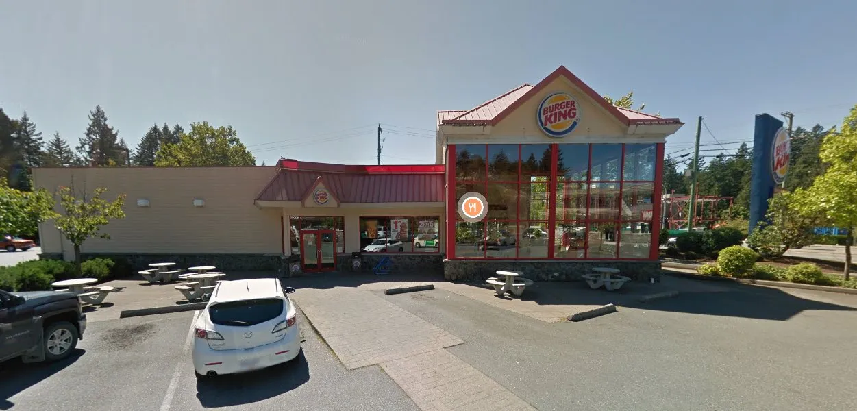 Street-level view of the Burger King restaurant exterior and parking lot