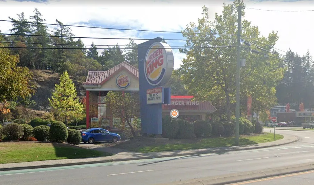 Street-level view of the Burger King site from Old Island Highway showing existing signage