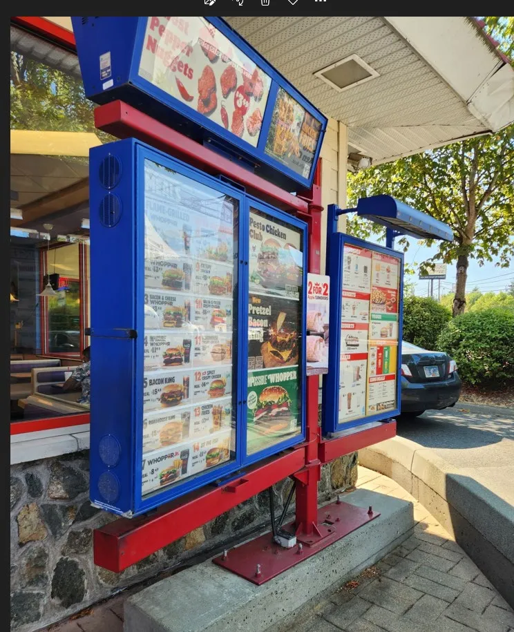 Photograph of an existing multi-panel drive-thru menu board structure