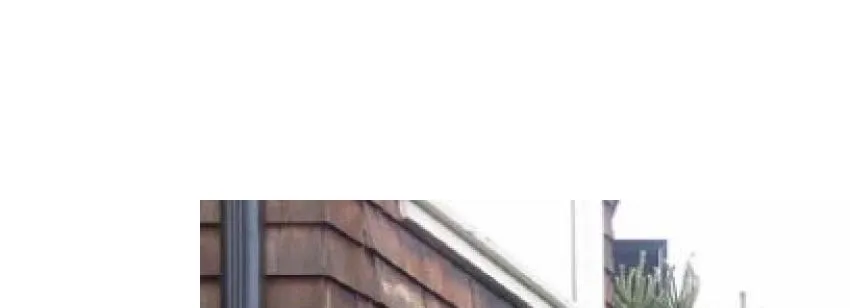 Building exterior corner with downspout and siding