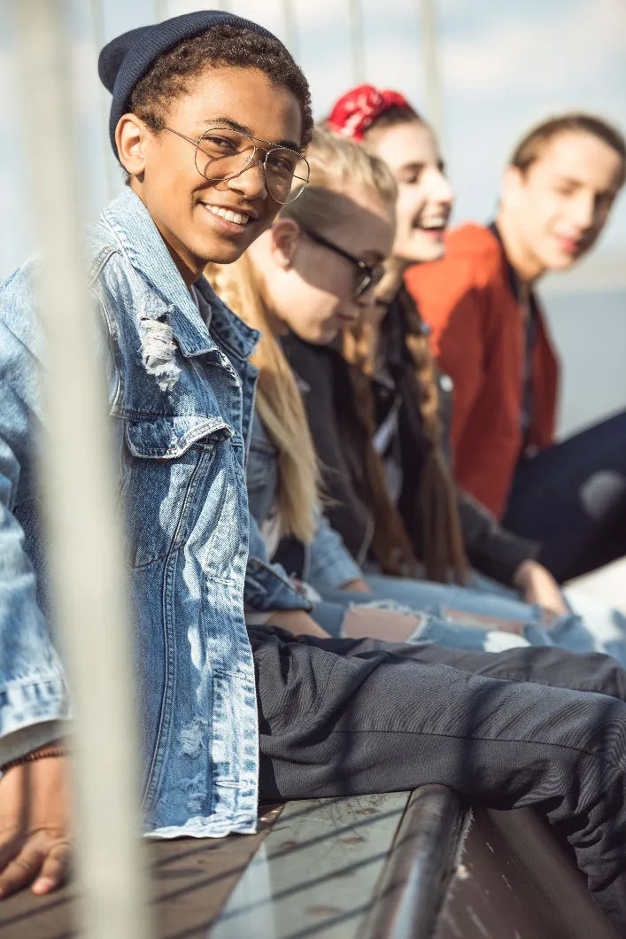 A group of four youth sitting outdoors