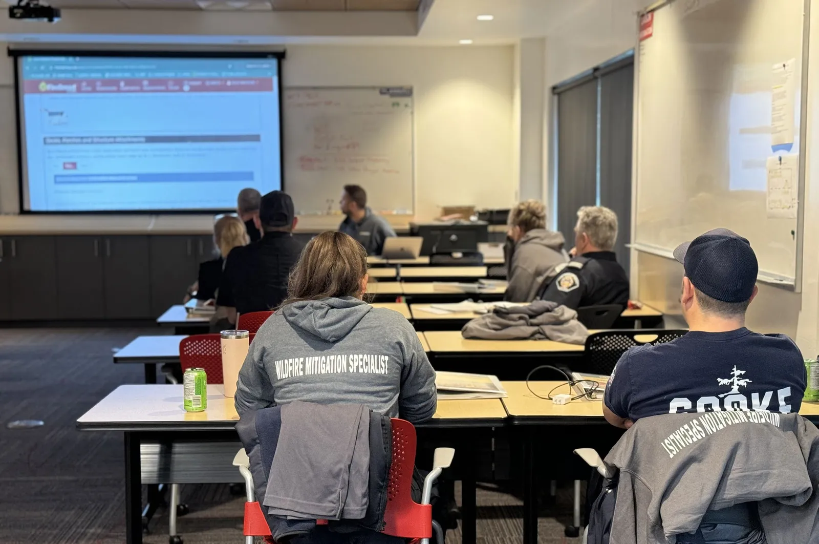 Department members attending a Wildfire Mitigation Specialist training session in a classroom setting