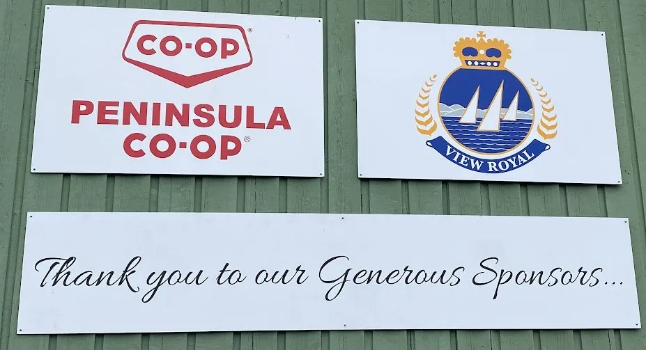 Signs on the exterior of the hall acknowledging Peninsula Co-op and View Royal as generous sponsors