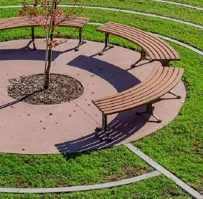 Photo of circular wooden benches around a tree on a paved surface