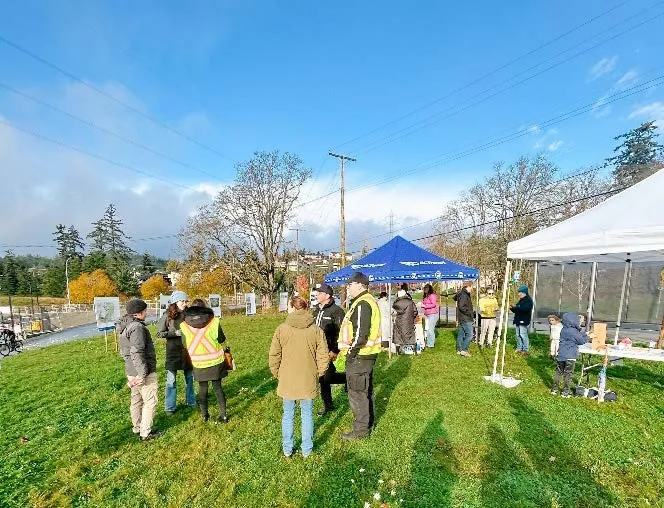 Joint Open House event with tents and people gathered on a lawn