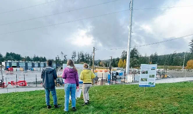 People looking at information boards at the Open House event