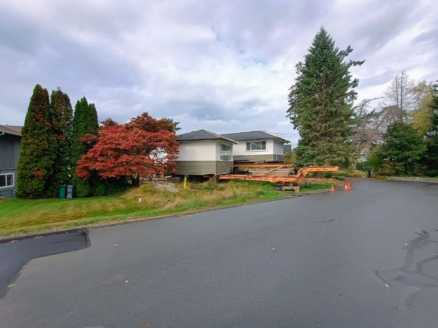 Street view of the subject property on October 2, 2025, showing the existing house relocated onto a trailer