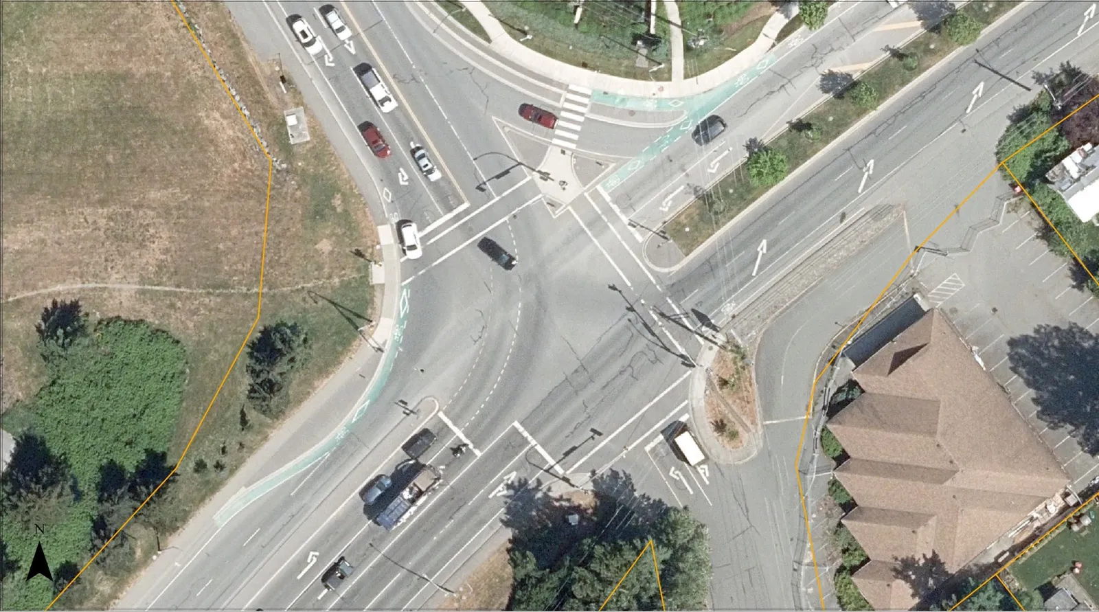 Annotated aerial view of the intersection showing Phase 1 movements (yellow) from Chancellor Avenue and Phase 2 movements (red) from Watkiss Way.