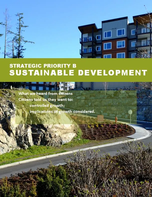 A modern multi-story residential building located near a rocky outcrop and a landscaped road