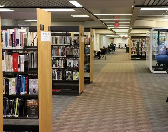 Wide interior shot of the Central Branch library showing book shelves and service counters.