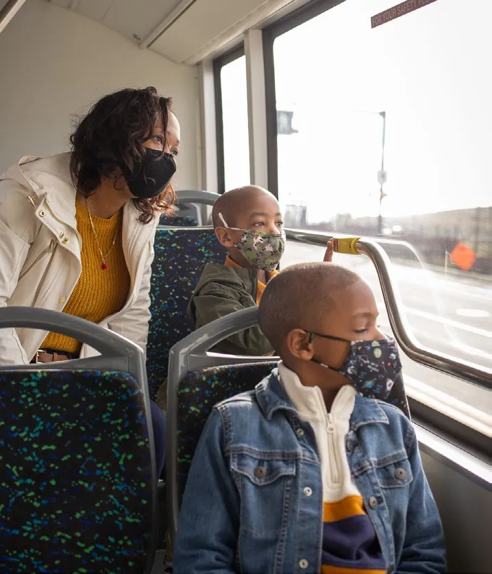 People wearing masks inside a bus