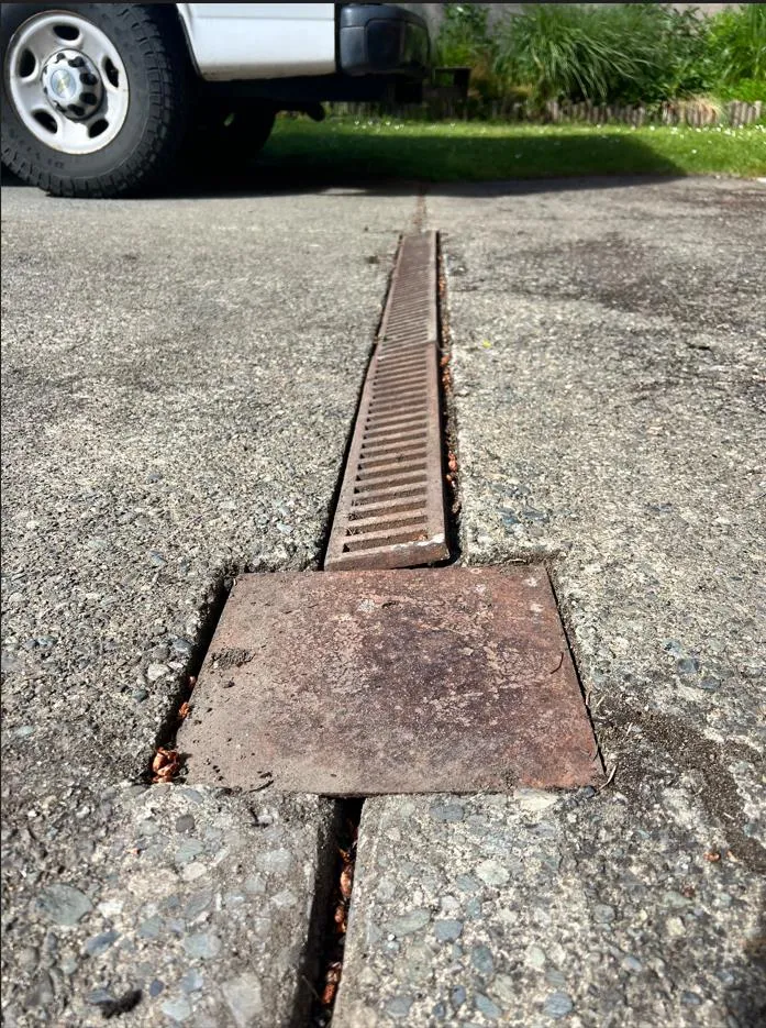 Detail of a channel drain grate and ground-down concrete section