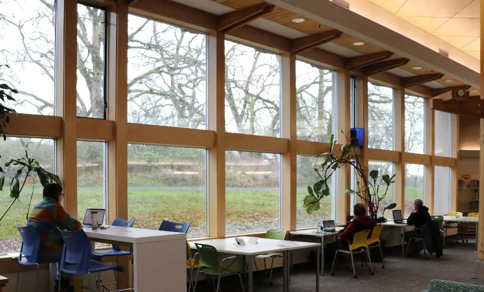 Wide interior shot of a library branch showing book stacks and seating areas.