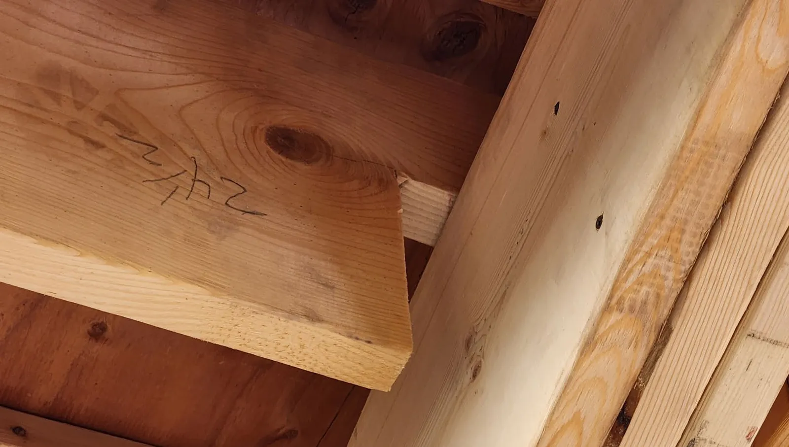 Photo of a notched wooden floor joist