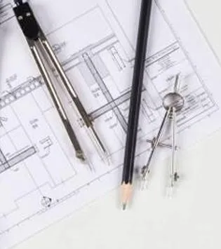 Drafting tools including a compass and pencil on a blueprint