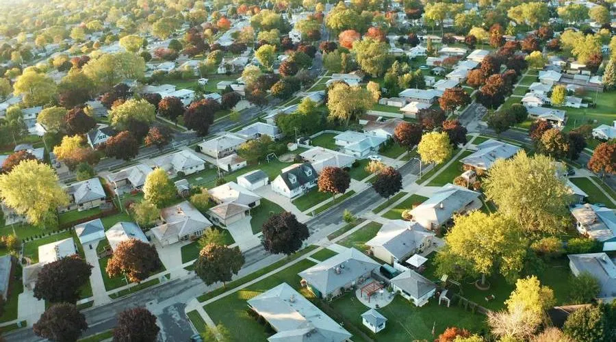 Aerial view of a residential neighborhood with green trees