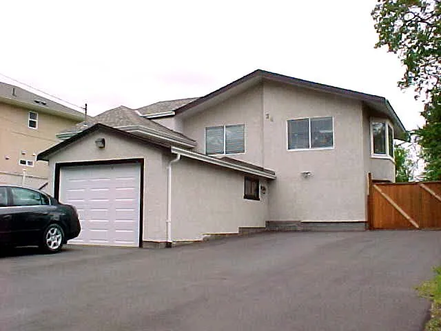 Original exterior of the house at 34 Vickery Road with beige stucco