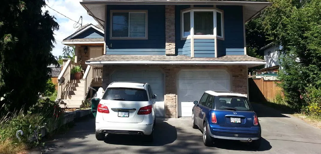 Renovated house at 34 Vickery Road with blue siding and two garages
