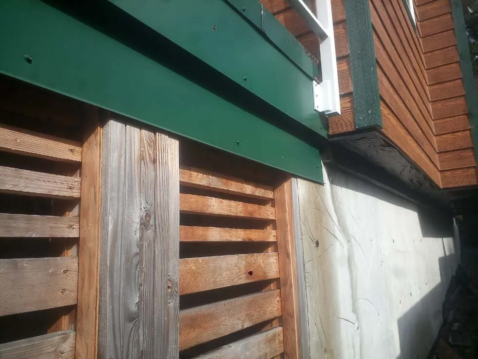 Close-up of wooden structural elements and Tyvek building wrap