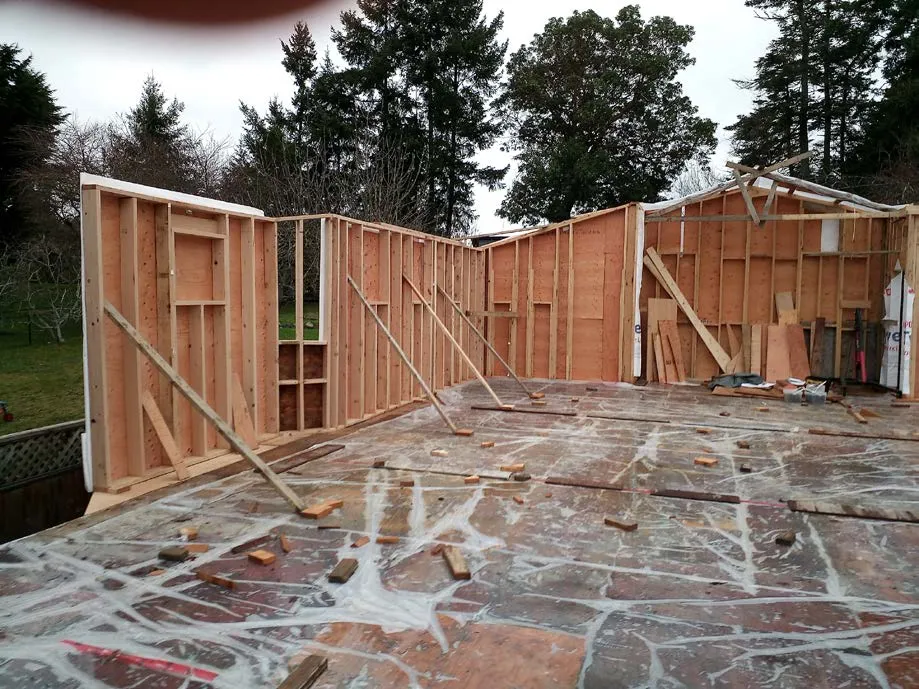 View of several metal joist hangers supporting floor joists