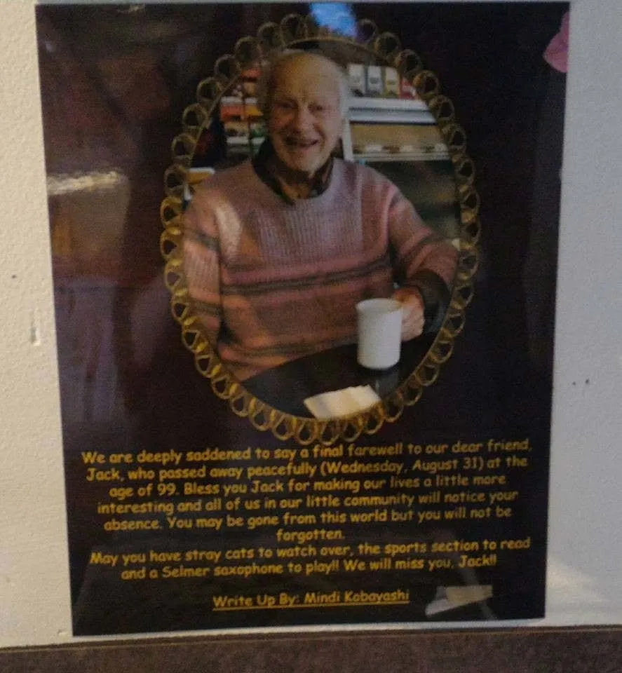 A commemorative plaque with a photo of Jack Cosier and a message about his passing on August 31 at age 99, mentioning his love of stray cats, the sports section, and the Selmer saxophone.