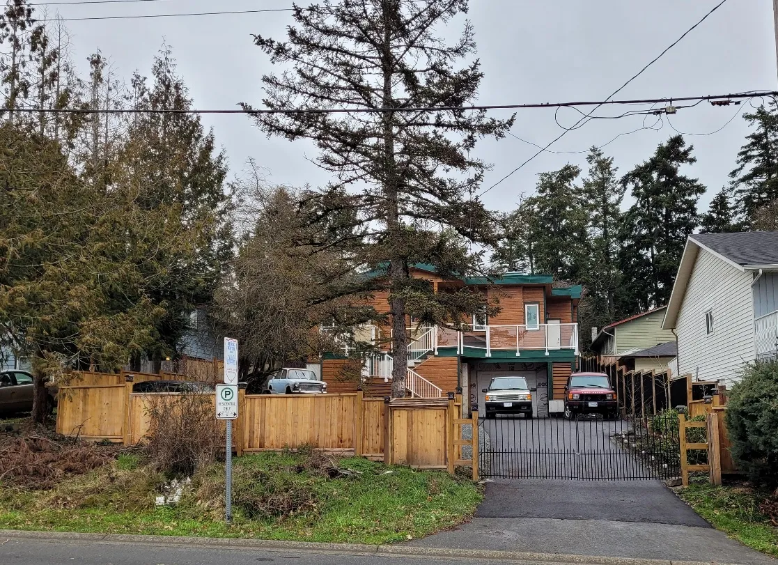 Photo of the 12 Vickery Road property showing the house, fencing, and gated driveway.