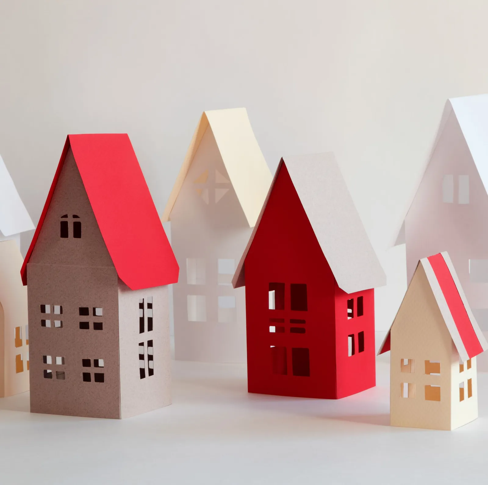 A group of colorful paper-cutout houses of various sizes and colors