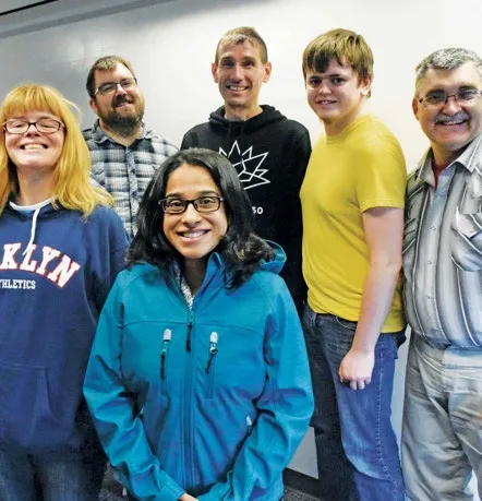 A group photo of six people standing together