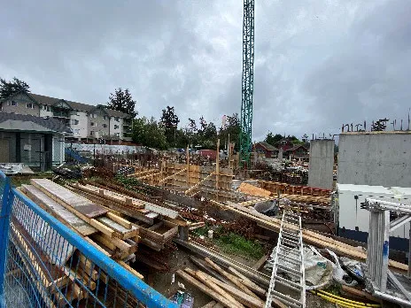 Construction site photo showing foundations and crane at 258 Helmcken Rd