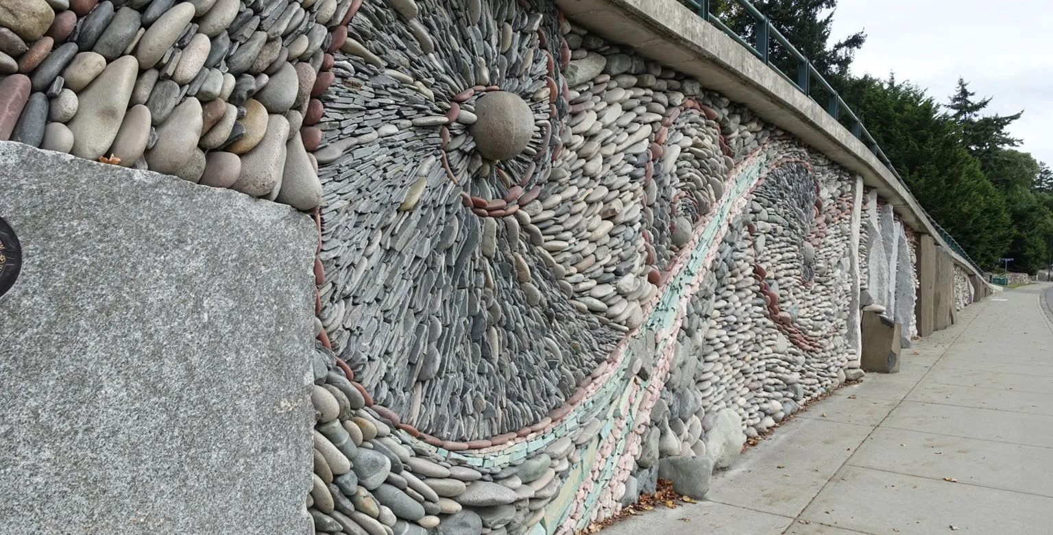 Background photo of "Love Story (The Great Wall of View Royal)" by Andreas Kunert, a detailed mosaic stone wall