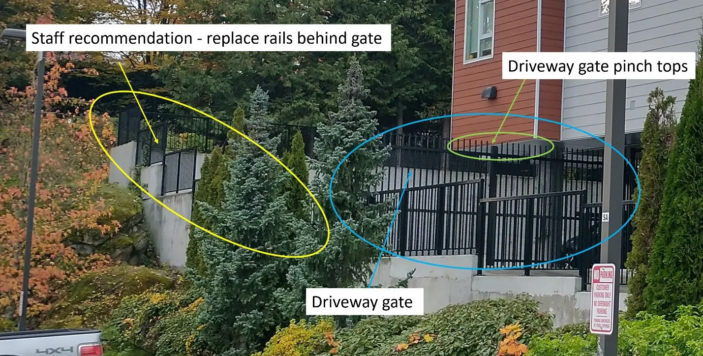 Detailed view of the driveway gate showing pinch tops and staff recommendation to replace rails behind the gate