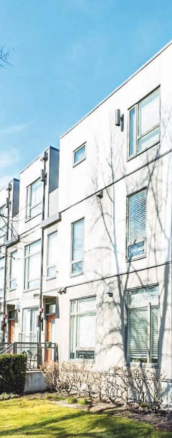 Modern multi-story townhouse complex with large windows