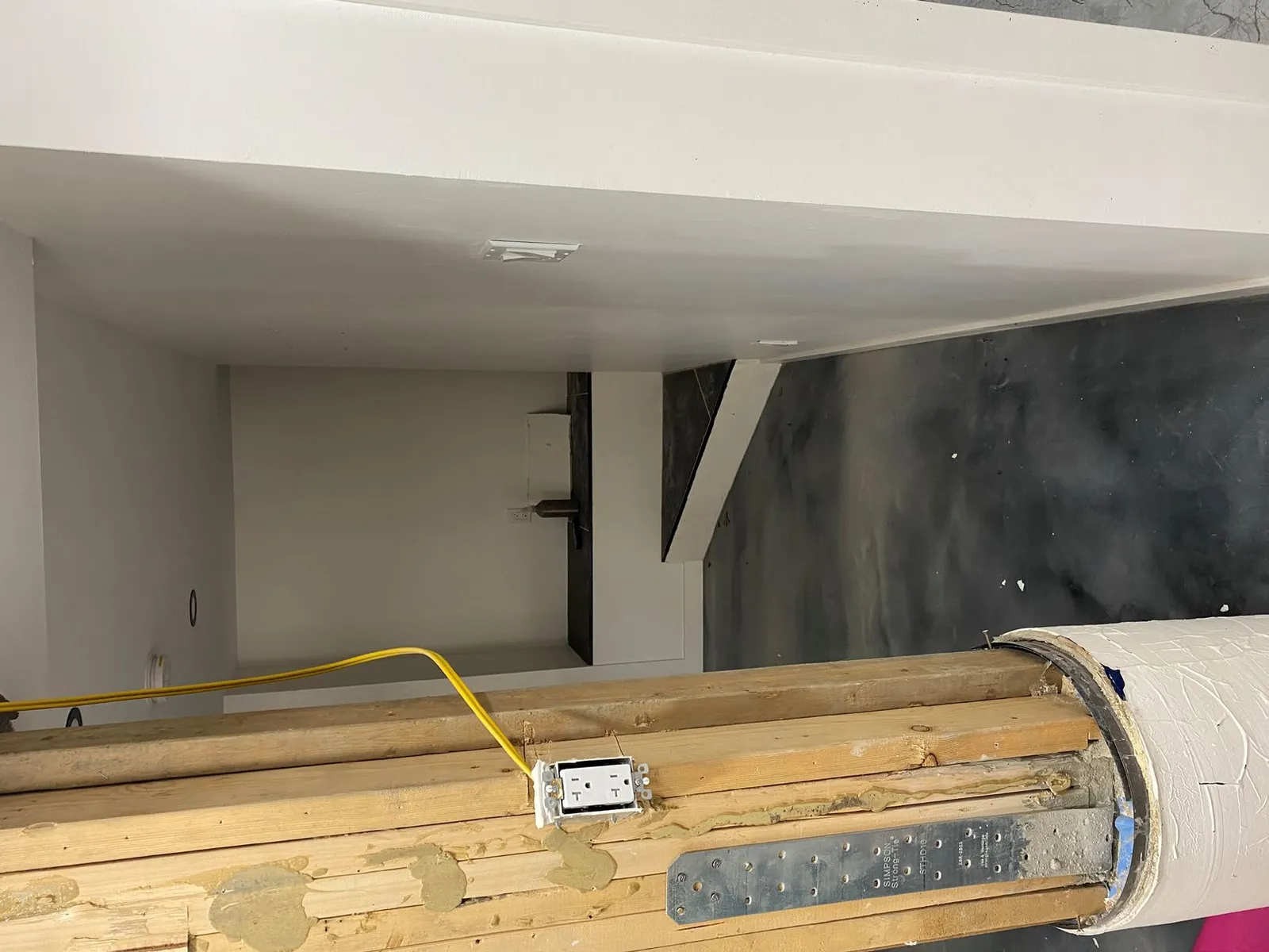 Wider view of the exposed structural post and surrounding interior area