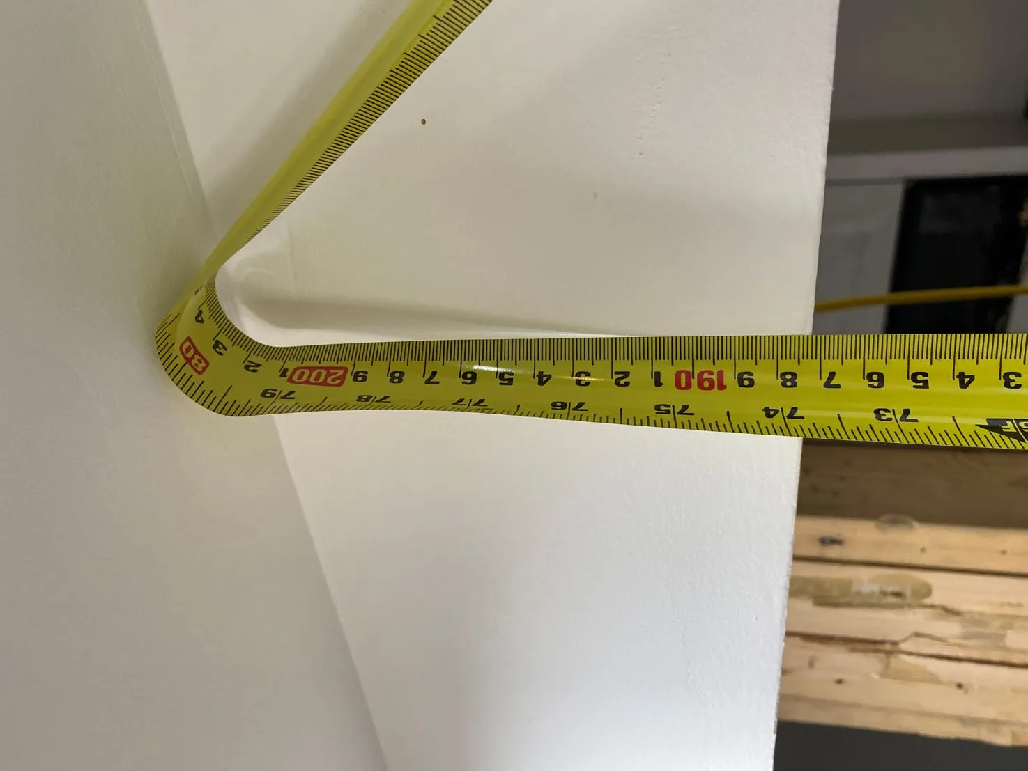 Tape measure measuring the height from the floor to the ceiling