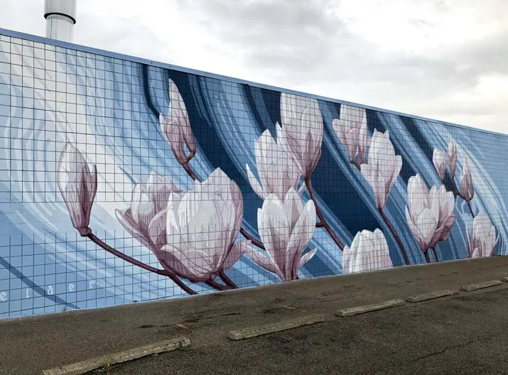 Multi-wall mural depicting white magnolia-like flowers on a background of blue, orange, and tan