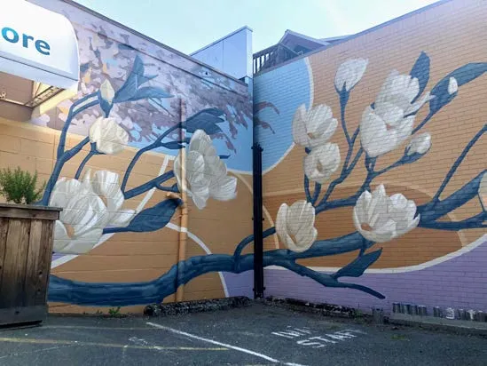 Detail of a mural featuring a large, stylized flower bud with intricate line work