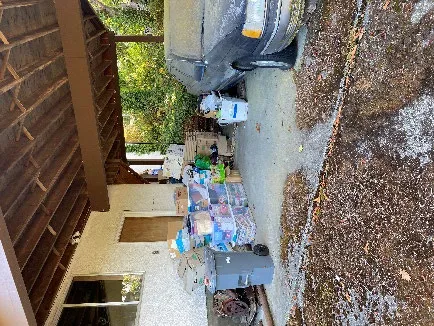 Outdoor stairwell heavily littered with debris, making it unsafe to navigate