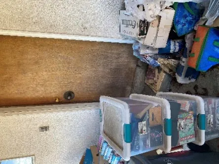 Doorway obstructed by an accumulation of containers and boxes