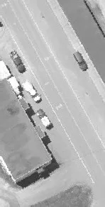Aerial view of a roadway with several cars