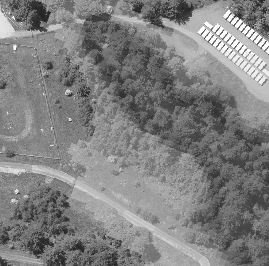 Aerial view of commercial structures and their parking facilities