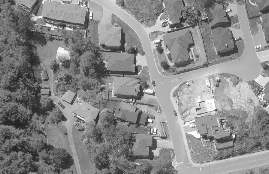 Aerial view of a road passing through a heavily treed area