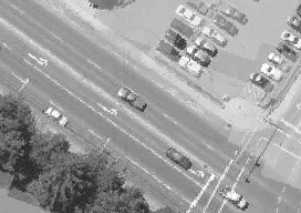 Aerial view of Island Highway with vehicles and adjacent parking lot
