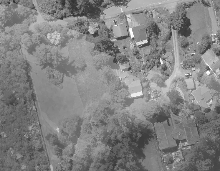 Aerial view of a major roadway through a commercial and wooded area