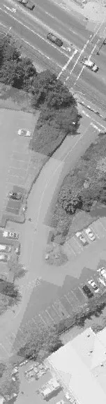 Aerial view of a large parking area with several parked cars