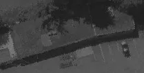 Aerial view of a parking lot area adjacent to a roadway
