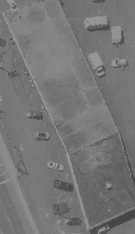 Aerial view of a commercial building and its parking lot